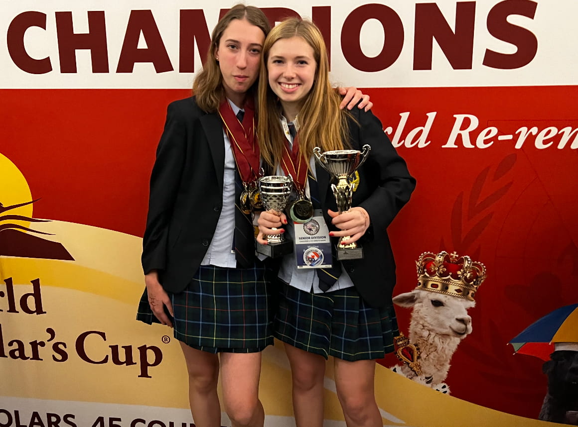 Martina Revello with her friend Eva holding trophy's after winning world scholars cup debate