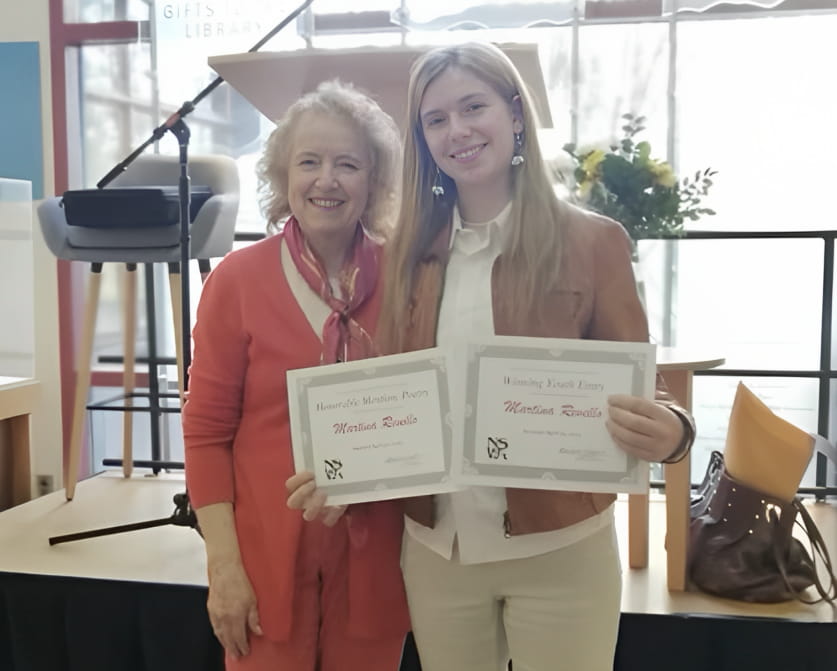 Martina Revello holding two awards after winning the North Shore Writers competition